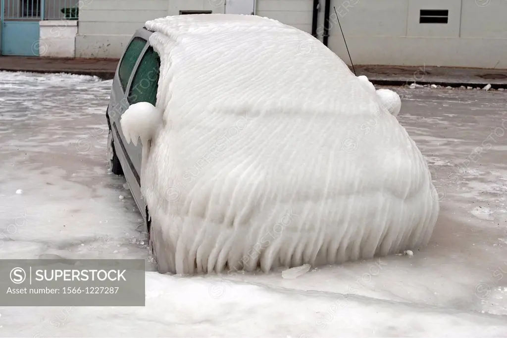 Severe winter, frozen car trapped in ice, Versoix, canton of Geneva, Lake Geneva region, Lake Geneva shore, Switzerland, water was blown out from the ...