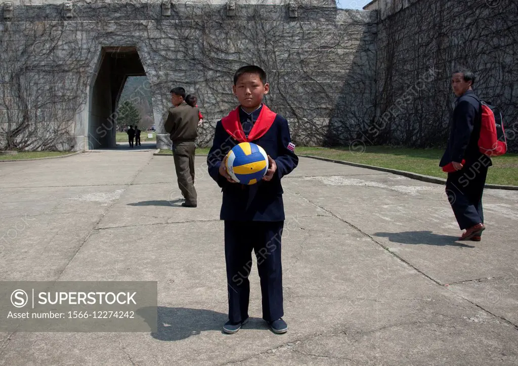Young Pioneer Holding A Ball In His Hands, North Korea.