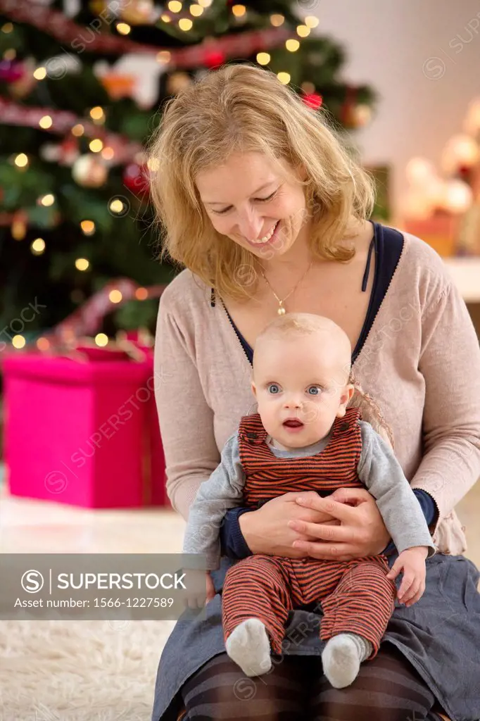 Mother with their six month year old baby at Christmas