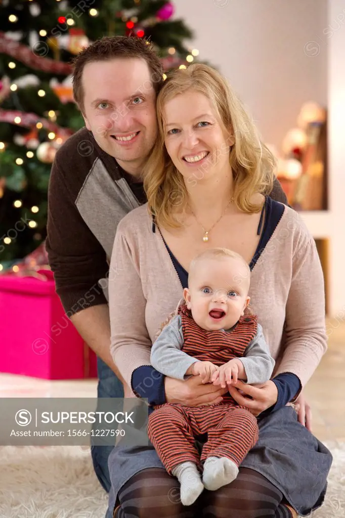 Family with their six month year old baby at Christmas