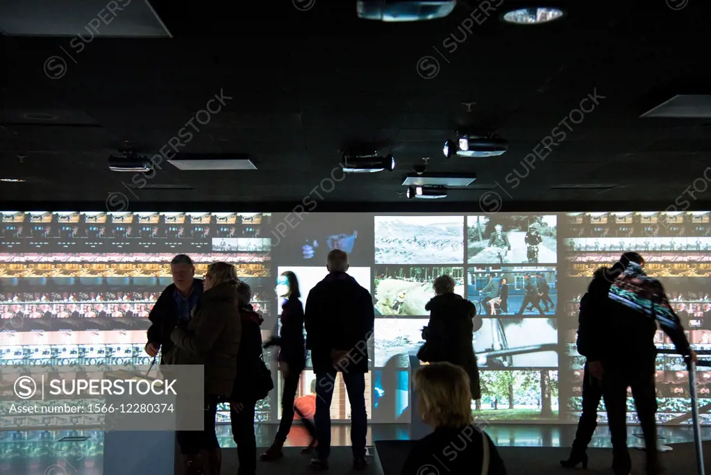 visitors watching many tv screens at Eye film museum in Amsterdam Holland