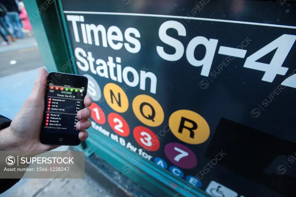 A subway rider checks the new MTA Subway Time app outside the Times Square station in New York Using the technology that is the engine behind the wide...