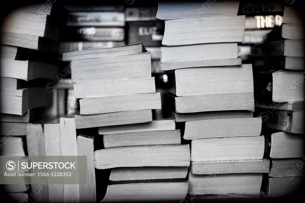 group of books stacked in a bookshop