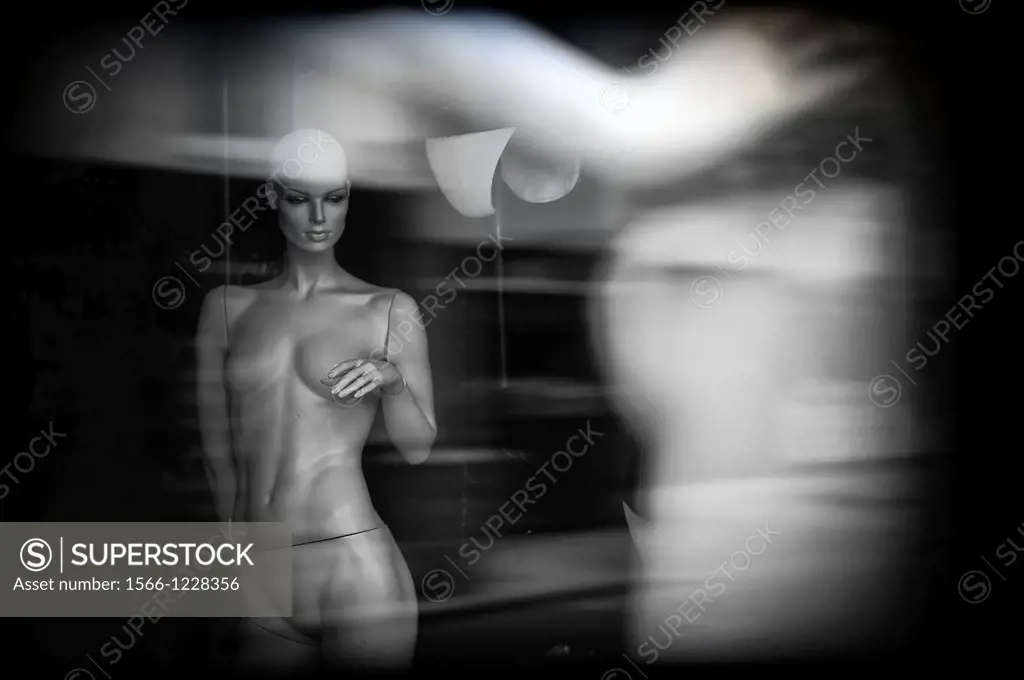 Female mannequin in a shop window naked,
