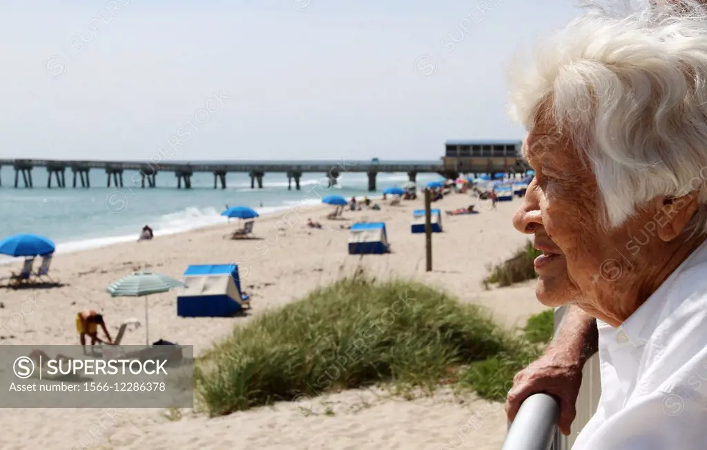 Florence Self, 90, looks over the beach goers enjoying the sun in South Florida.