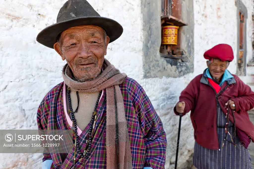 Two old men circling Jampa Lhakhang Temple, Jakar, Bumthang, Bhutan, Asia.