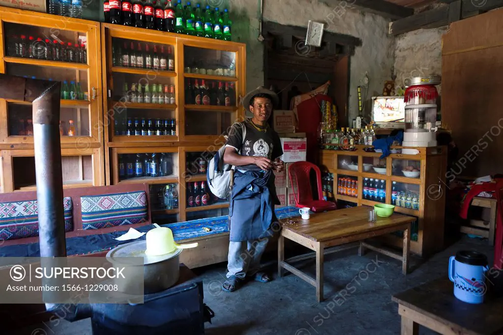 Local man in a general store, Trongsa Town, Bhutan, Asia.