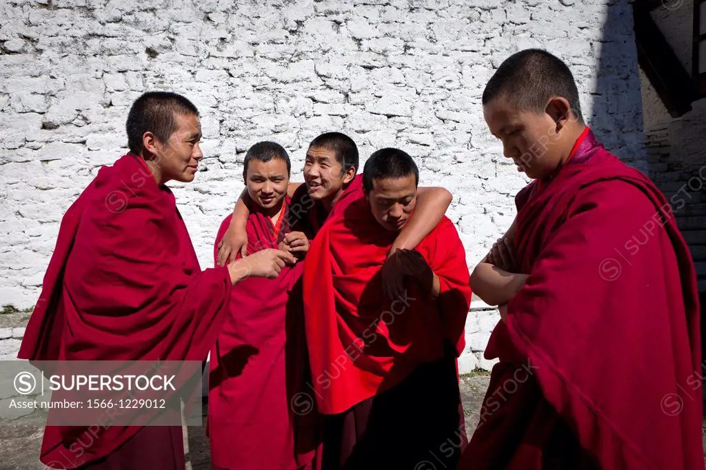 A group of monks in the patio of Trongsa Dzong, Trongsa, Bhutan, Asia.