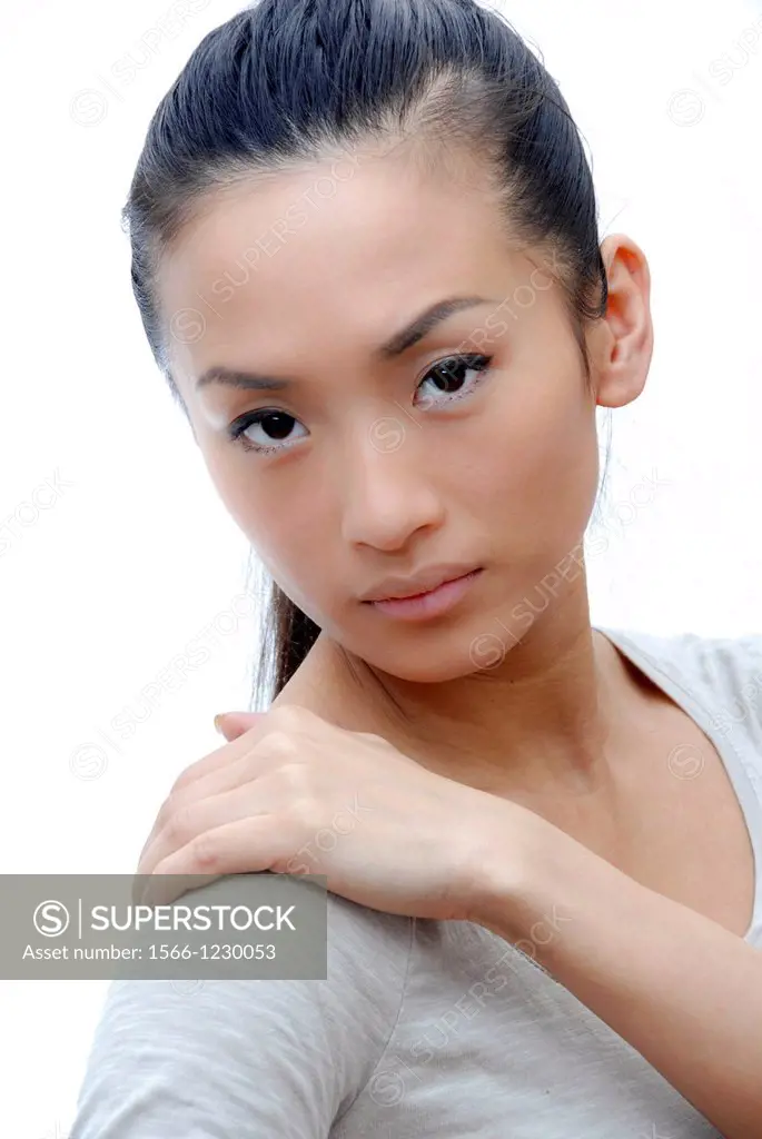 Woman holding her hand against her painful shoulder