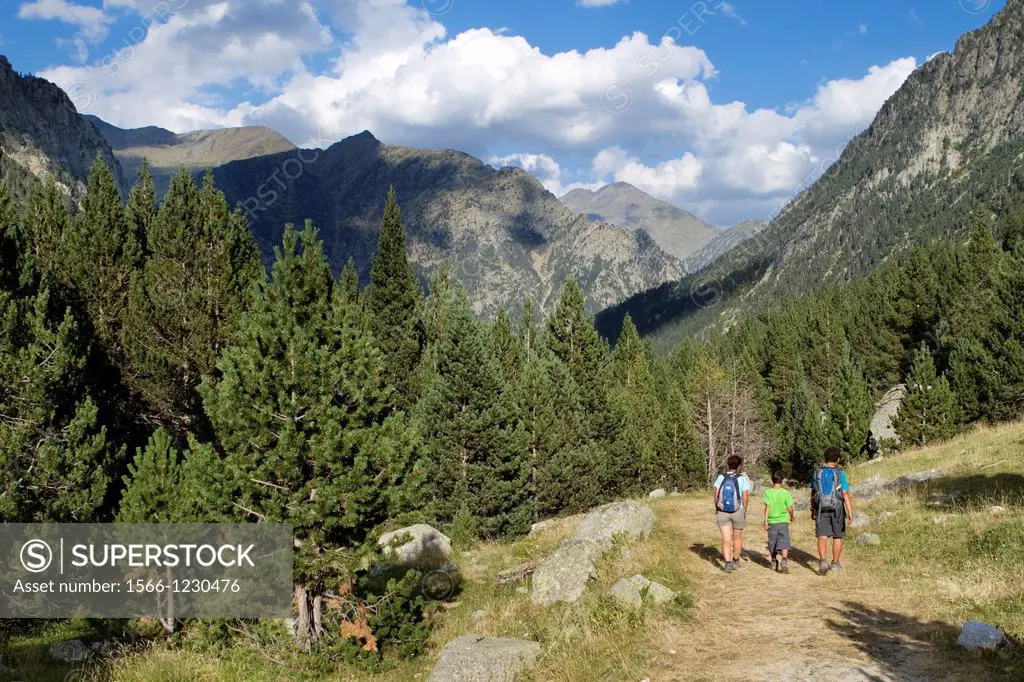 Hikers walking along Barrosa valley, a typical glacier valley of aragonese Pyrenees  Huesca  Spain