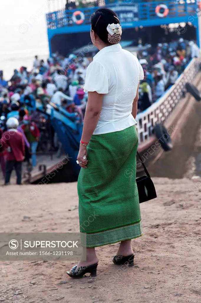 Khmer woman waiting for the ferry to cross the Tonle Sap river in Phnom Penh Cambodia