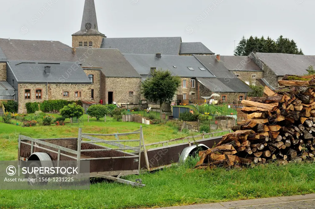 foreshortening of stack of wood and old carts in agricultural village, shot in typical cloudy light