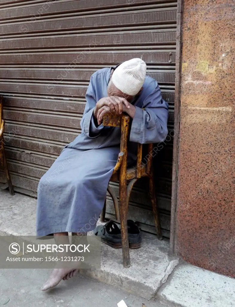 Egypt. Street scenes in so called ´Islamic Cairo´, the old quarter of the city near Bab Zuela. Old man sleeping