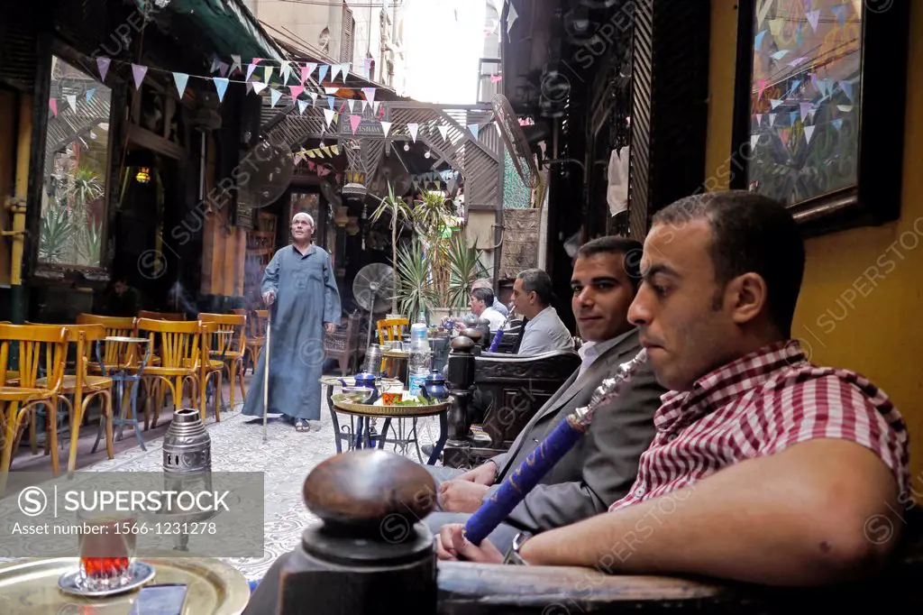 Egypt. Street scenes in so called ´Islamic Cairo´, the old quarter of the city near Bab Zuela. Man smoking shisha pipe