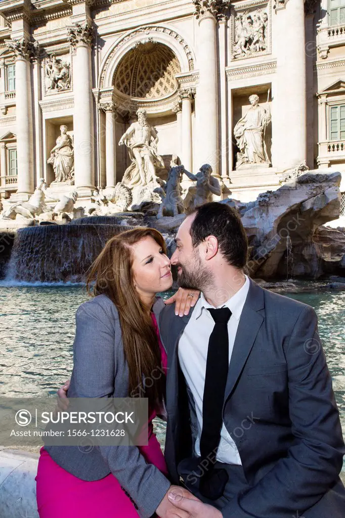 Couple kissing at Piazza Fontana di Trevi Rome Italy