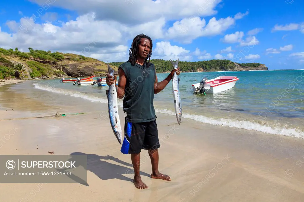 Local fisherman with fish from a fresh catch at Savannes Bay, St Lucia