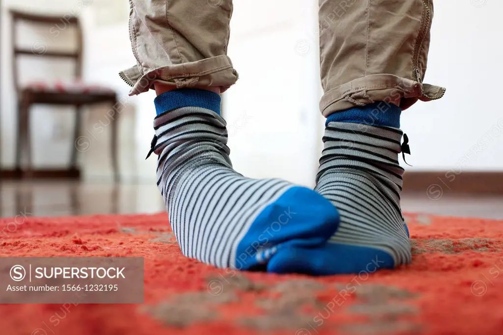 close up feet with striped socks in a house,