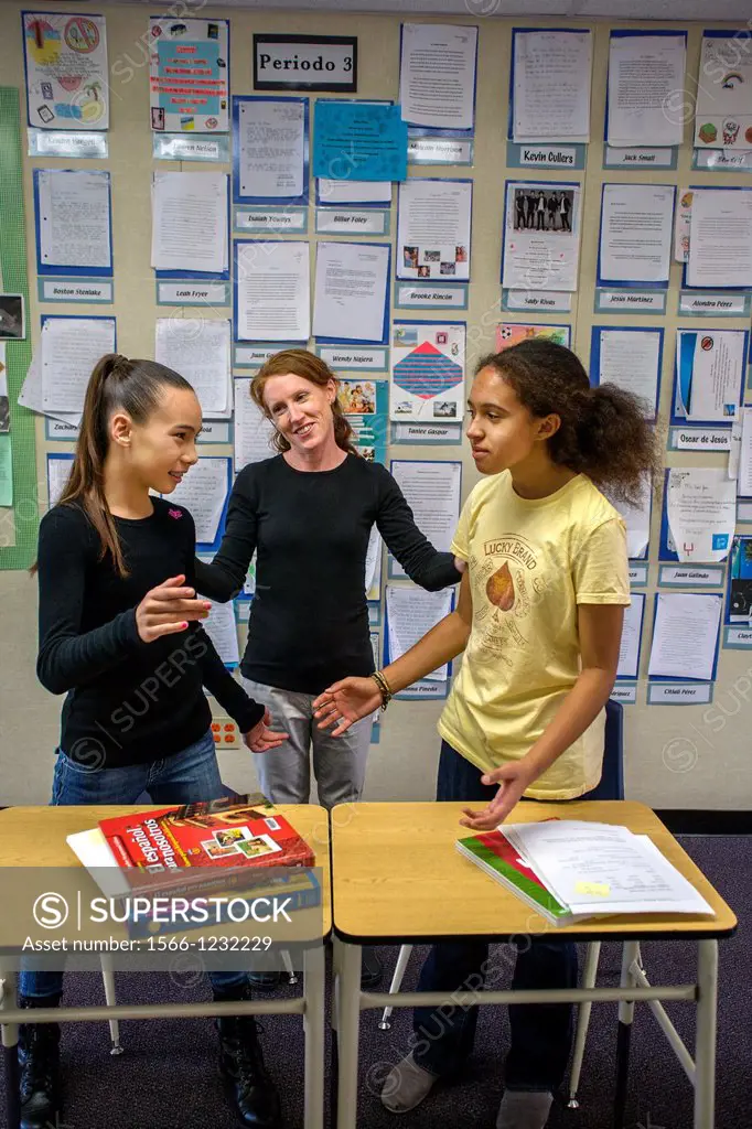 An intermediate school teacher resolves a dispute between two students in her San Clemente, California, classroom