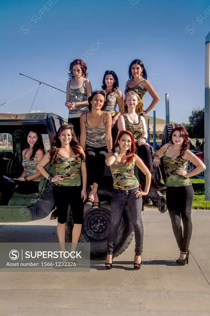 Enthusiastic women community college students show their support for the American military by wearing camouflage patterned tank tops at a U S  Marine ...