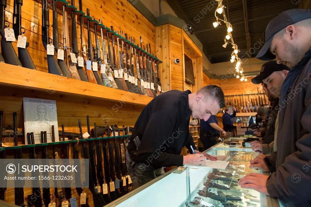 Milford, Michigan - A worker looked over paperwork for a gun buyer´s background check as customers crowded the Huron Valley Guns store on Gun Apprecia...