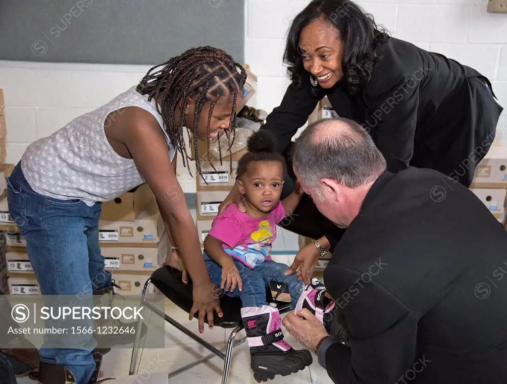 Detroit, Michigan - Residents of a Salvation Army shelter for homeless women and children try on winter boots  The boots were donated by Toyota Motor ...