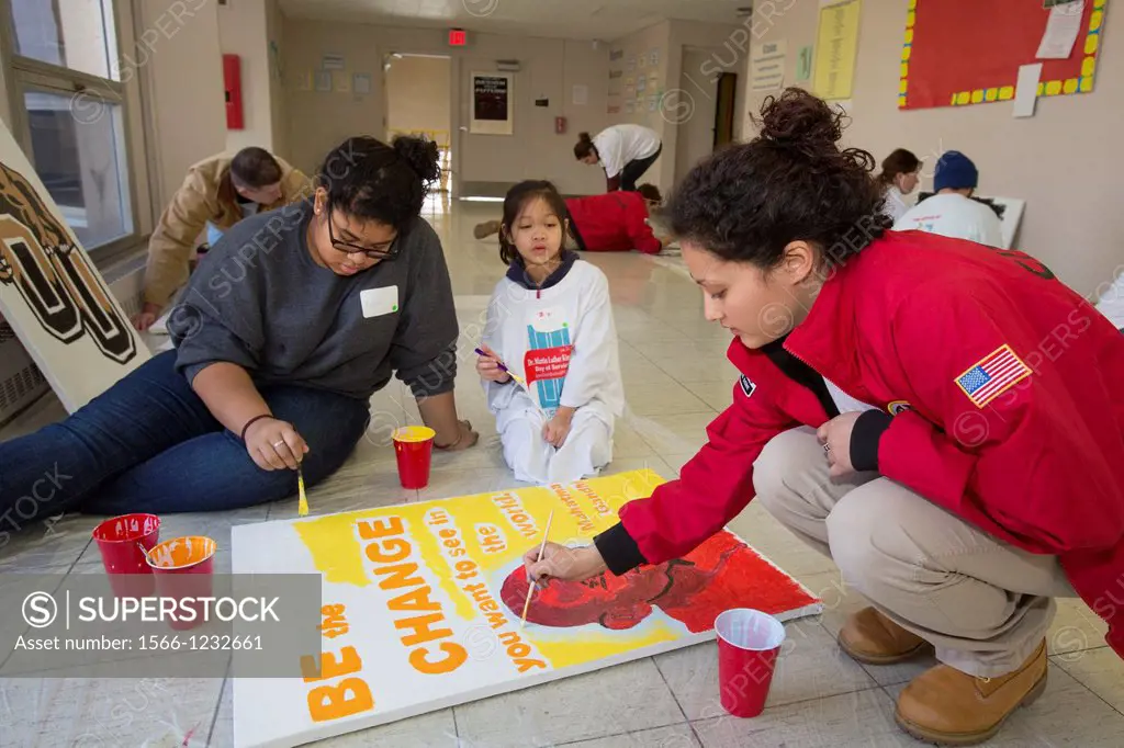 Detroit, Michigan - On Martin Luther King Jr  Day, volunteers from the Detroit Public Schools and City Year painted posters to hang at Detroit College...
