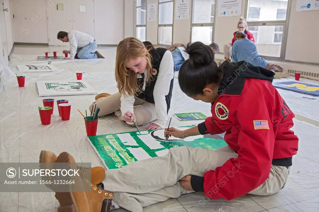Detroit, Michigan - On Martin Luther King Jr  Day, volunteers from the Detroit Public Schools and City Year painted posters to hang at Detroit College...