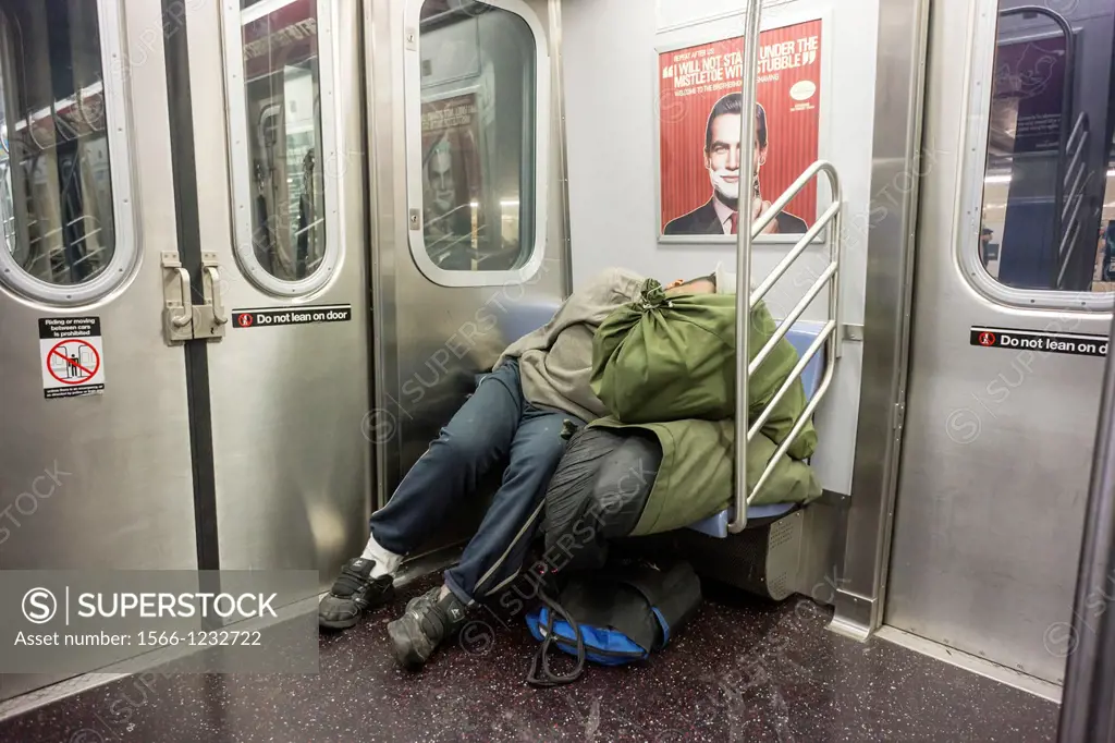 Homeless man escapes the cold and sleeps in a subway car in New York