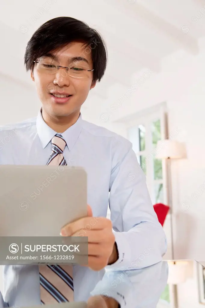 Young Asian businessman communicating on his Tablet computer