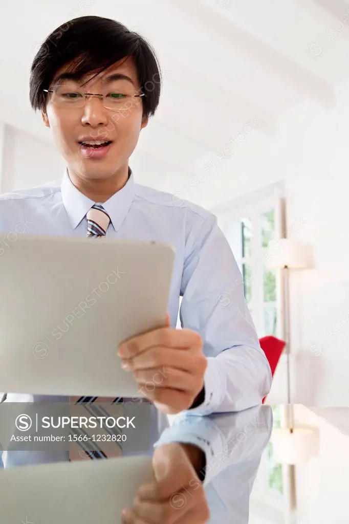 Young Asian businessman communicating on his Tablet computer