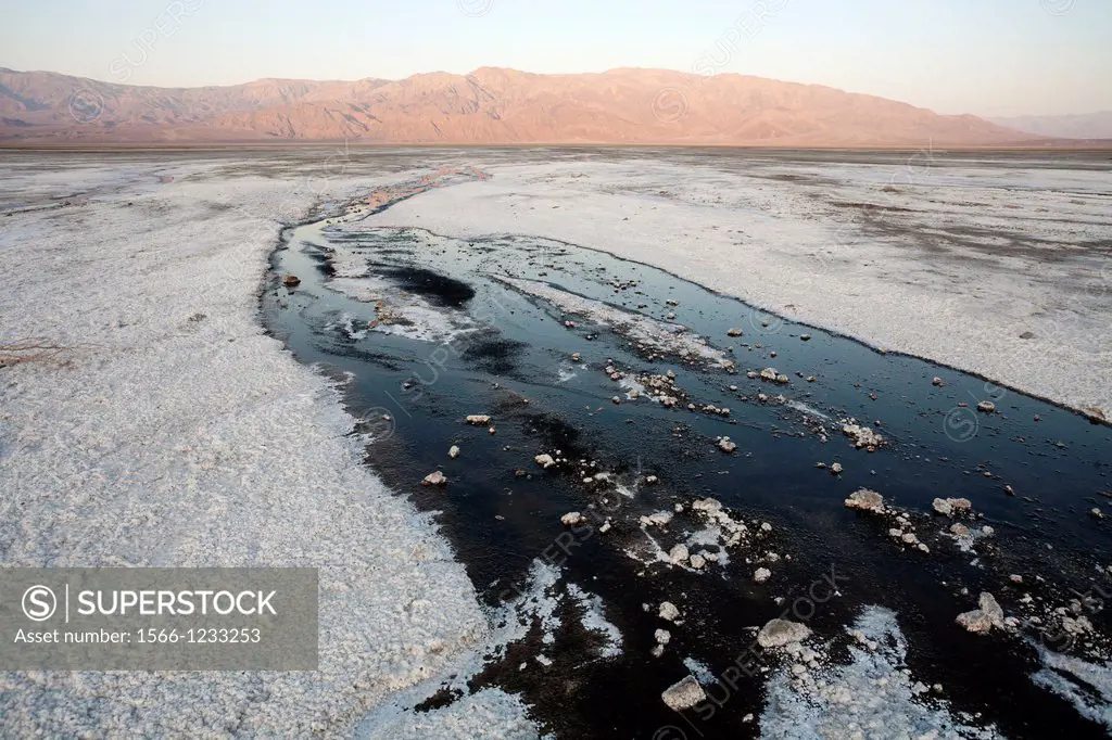 Salt marshes against the background of the Panamint Range in the central Death Valley at sunrise  Death Valley National Park, California, USA