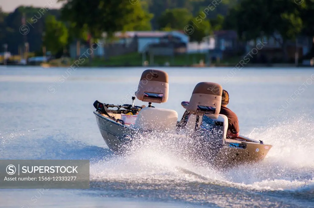 A motor boat speeding away splashing the water.