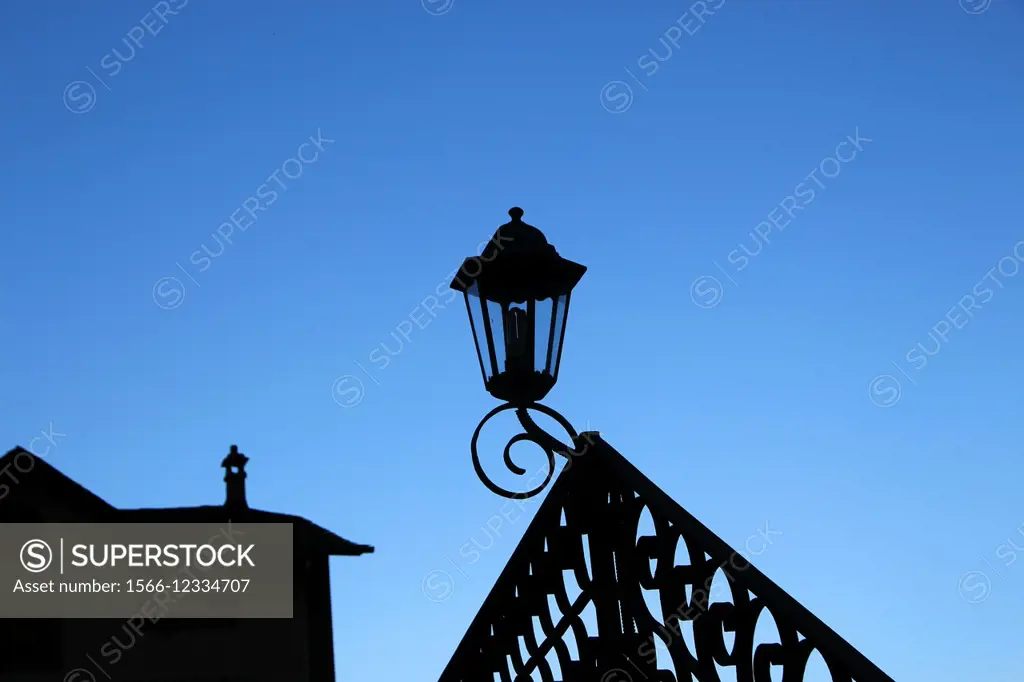 Decorative street light and a roof of house in twilight. Ordino, Andorra, Europe.