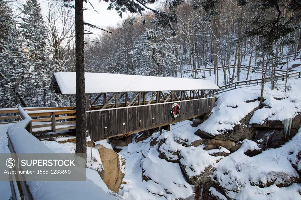Franconia Notch State Park - Sentinel Pine Covered Bridge during the winter months  It is a footbridge which crosses over the Pemigewasset River in Li...