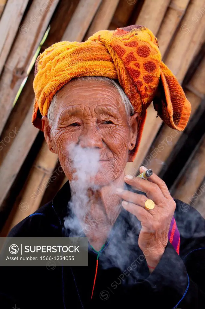 Cheroot, old woman smoking a typical cigar made of corn leaves in Inle, Myanmar, Burma