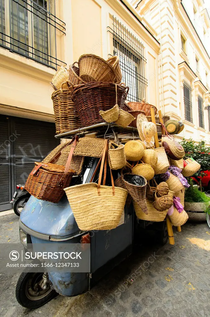 Baskets and straw bags over an Ape Car - Rome, Italy.