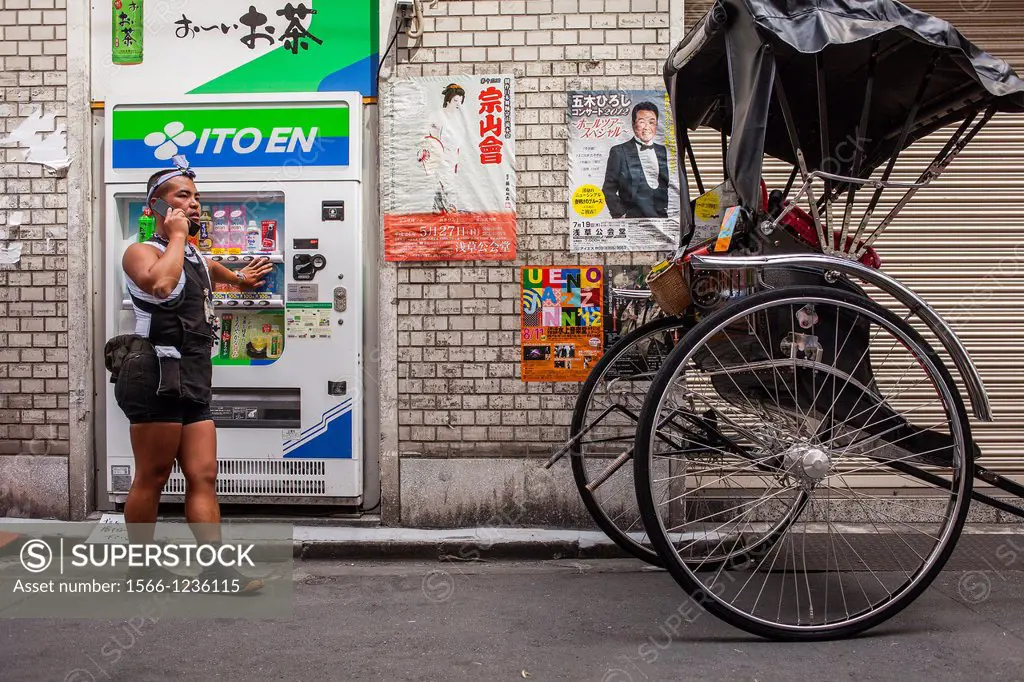 rickshaw talking on phone, in 2 chome street,next to Sensoji Temple, Asakusa, Tokyo, Japan, Asia
