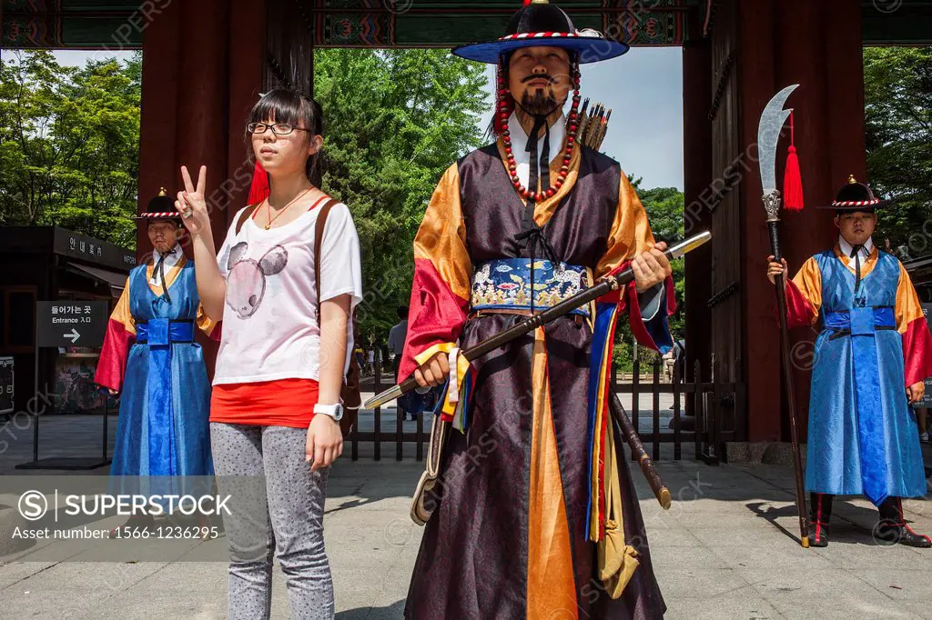 Ceremonial guards and tourist at gate of Deoksugung Palace, Seoul, South Korea
