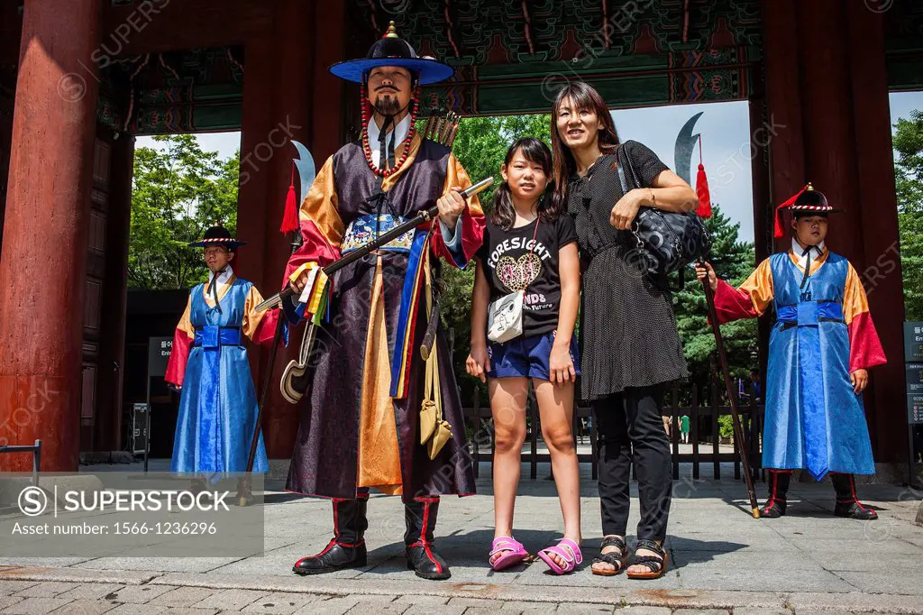 Ceremonial guards and tourists at gate of Deoksugung Palace, Seoul, South Korea