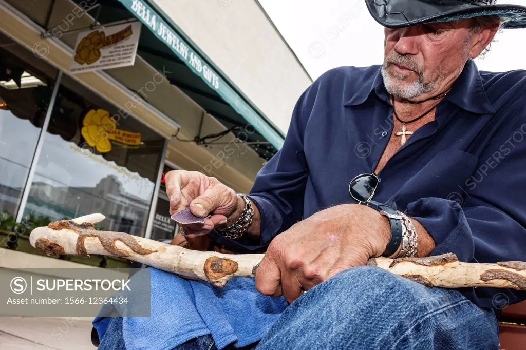 Florida, Stuart, Osceola Street, man, carving, walking stick