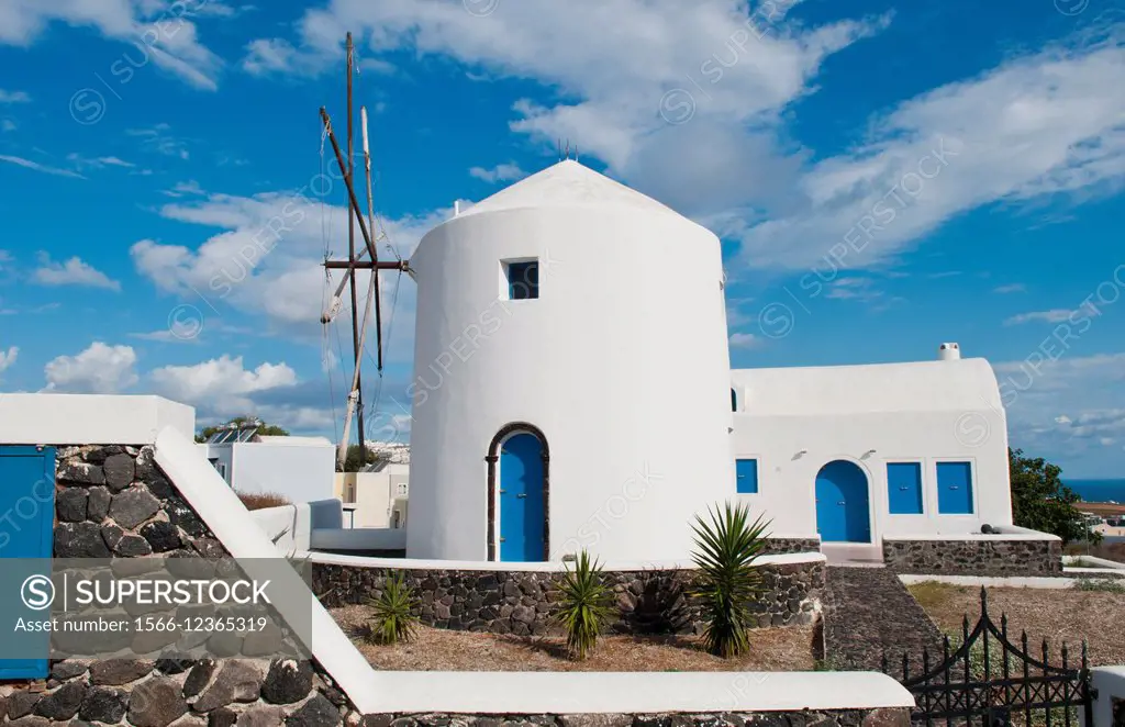 White windmill house in town in valley of Fira in Santorina Greece in Greek Islands