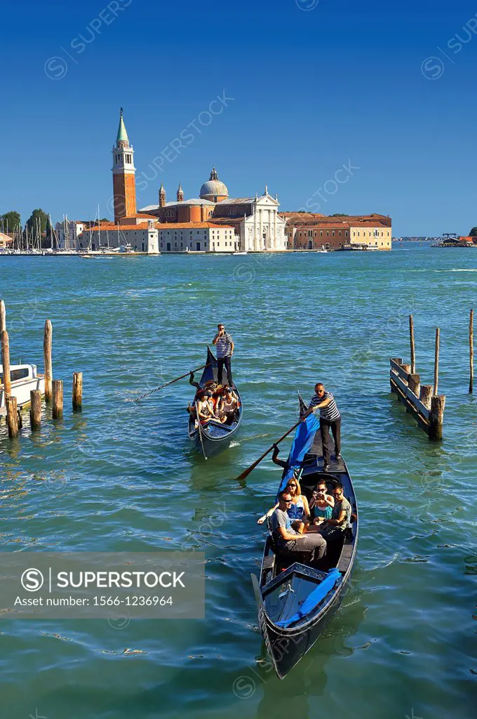 Gondolas at St Mark´s Square with the island of San Giorgio Maggiore behind , with its church front designed by Andrea Palladio and begun in 1566  Ven...