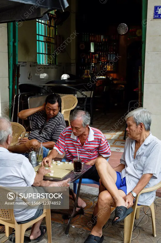 Men playing board game, Can Tho, Mekong Delta, Vietnam.