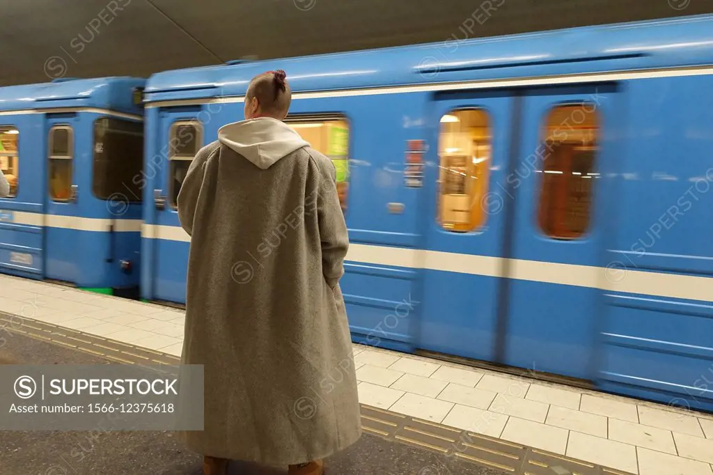 Midsommarkransen subway stop: woman with winter cape, Stockholm, Sweden