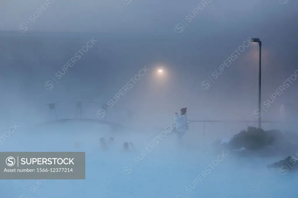 People swimming in the geothermal hot springs at the Blue Lagoon, Iceland.