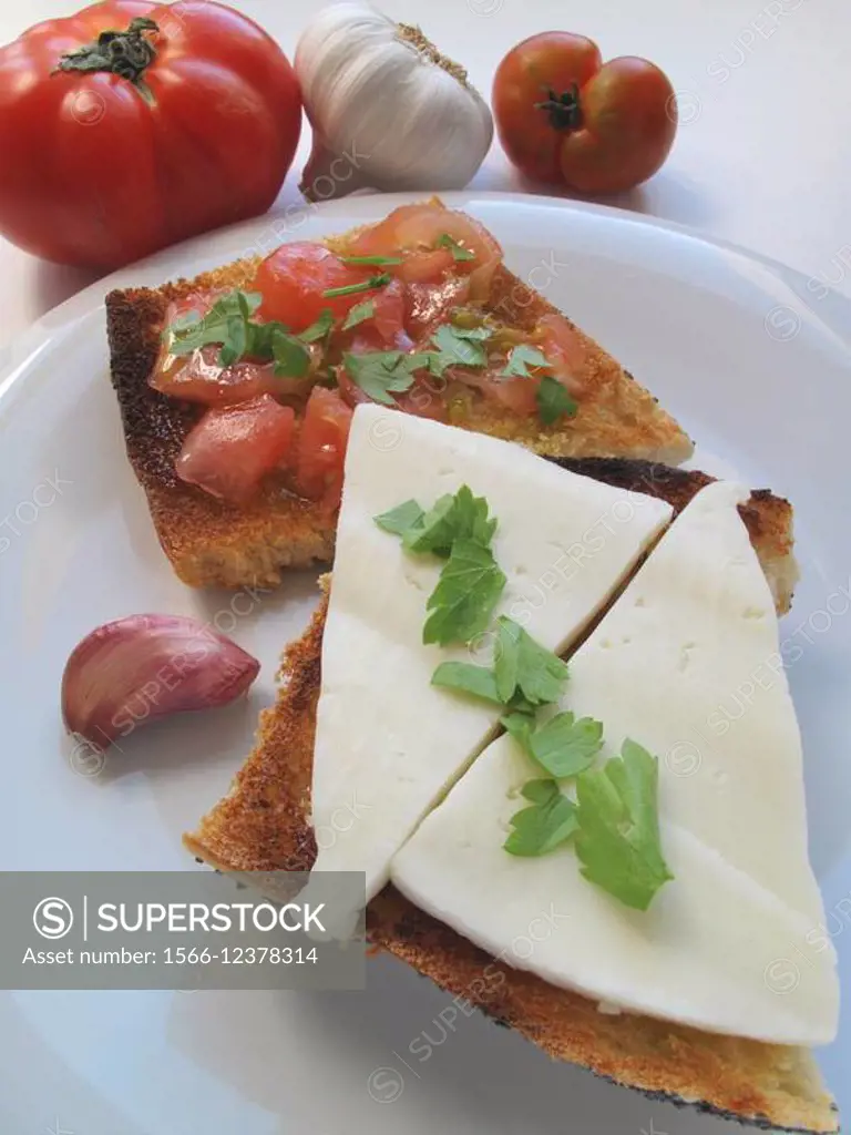 Toasted bread with garlic, oil, Parsley, Tomato and Cheese
