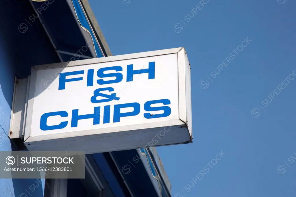 Fish and Chips Sign against Blue Sky Background.