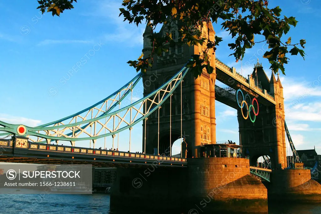 Tower Bridge in London England seen in the warm light of late evening with the Olympic rings displayed during the Olympics of 2012