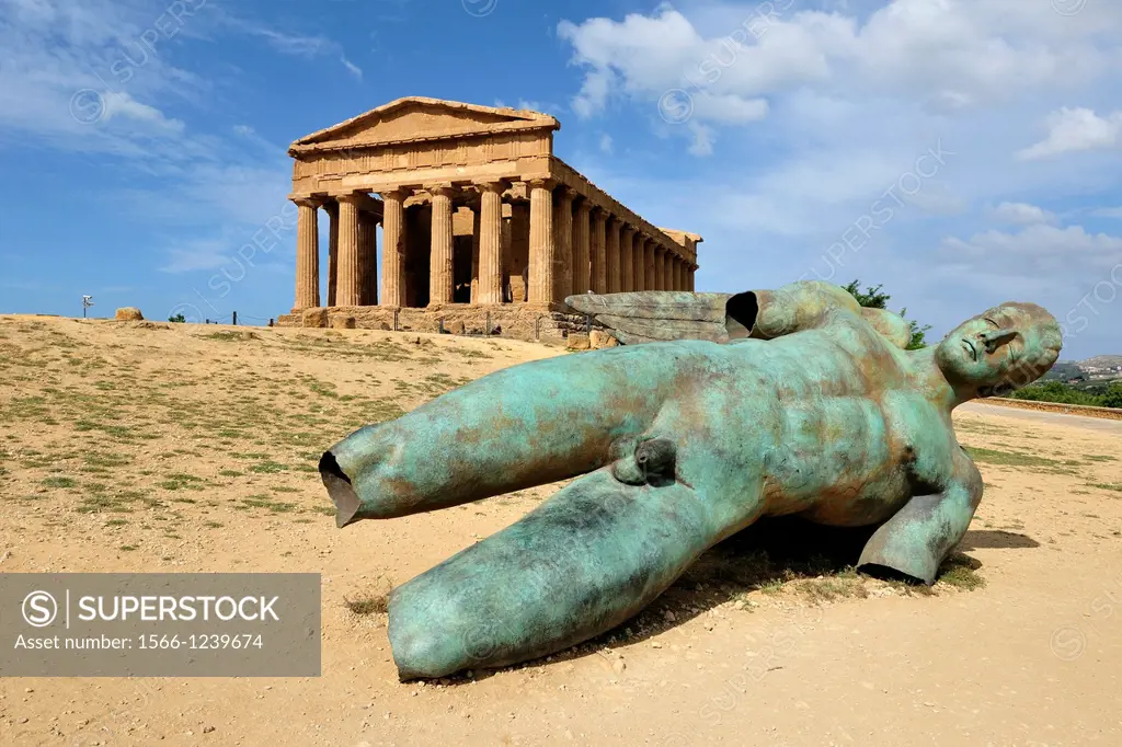 Agrigento  Sicily  Italy  Temple of Concordia & Fallen Ikarus sculpture by Igor Mitoraj, Valley of the Temples archaeological site