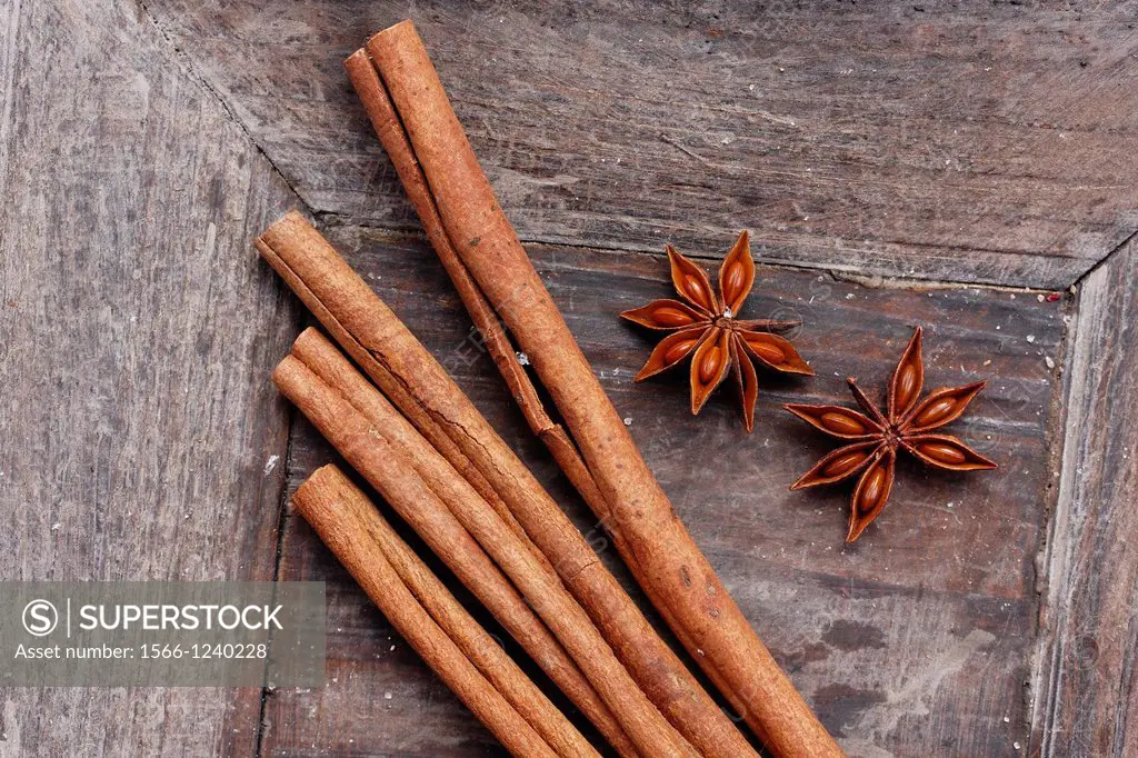 fruits of star anise - Illicium verum - cinnamon sticks in wooden bowl - Cinnamomum cassia